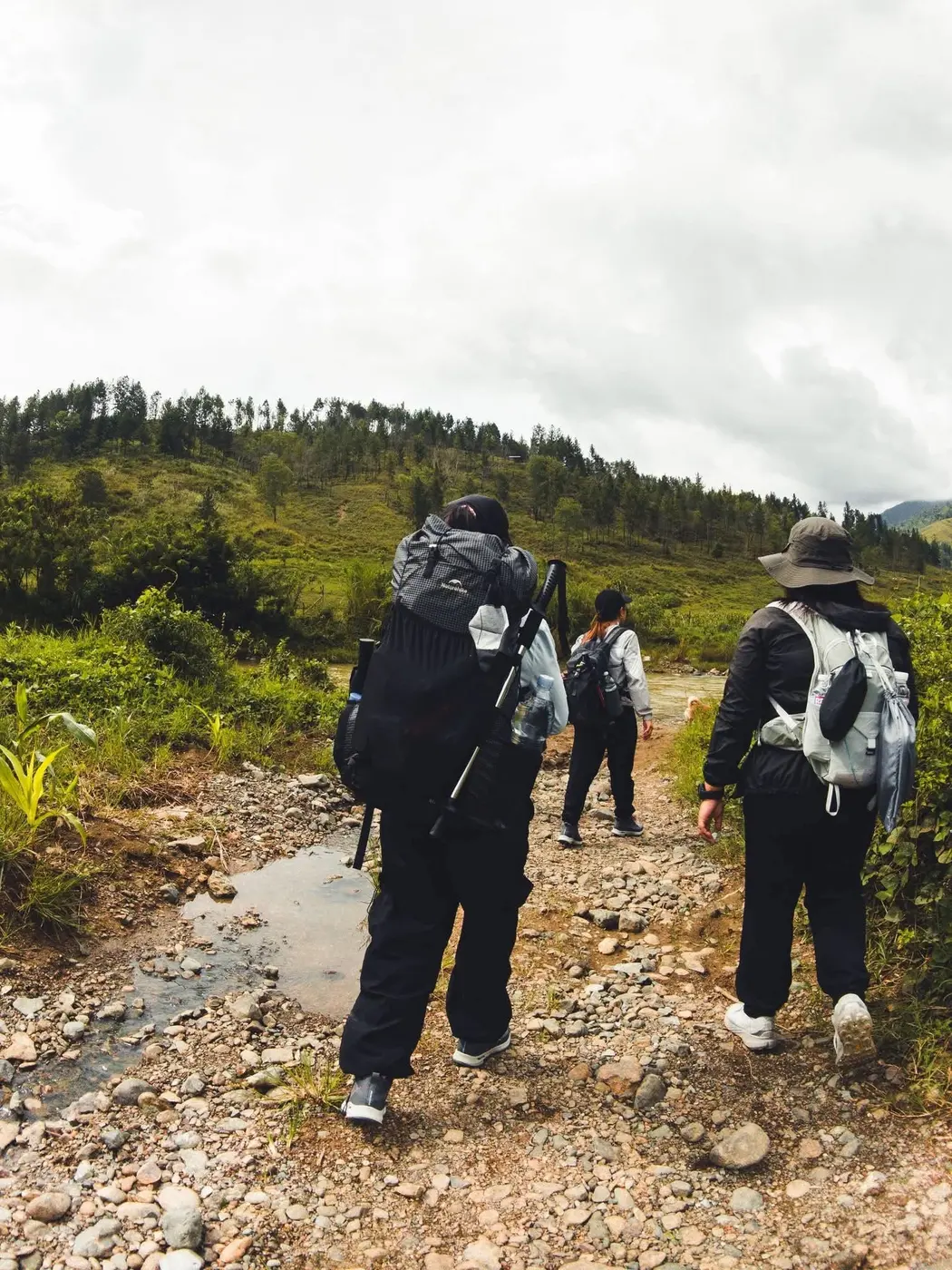 Hikers with backpacks on a rocky mountain trail