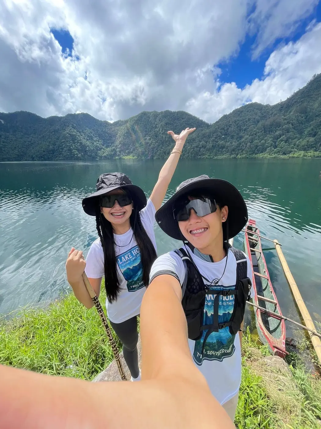 Two hikers posing beside Lake Holon