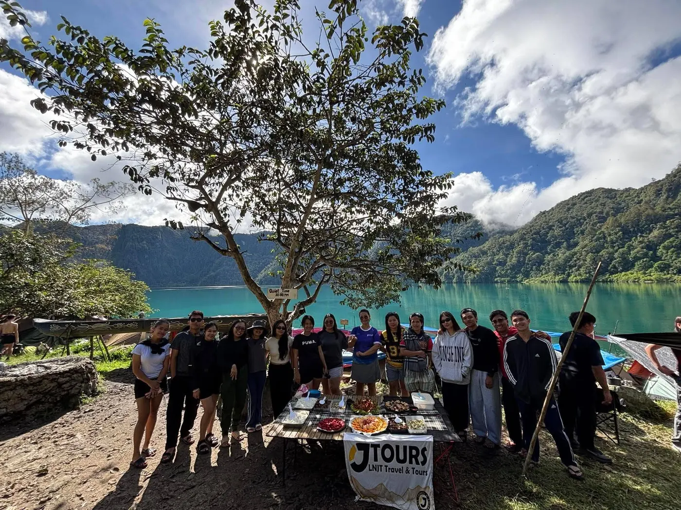Group gathered at a lakeside table at Lake Holon
